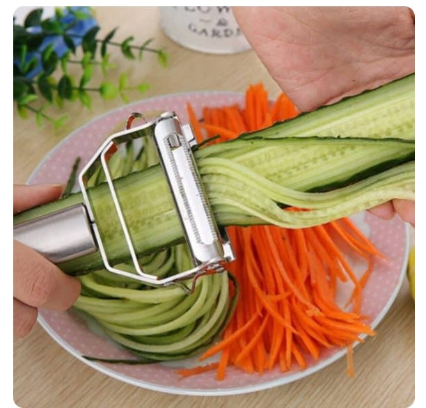 Hand using the 2-In-1 Peeler to peel a carrot.